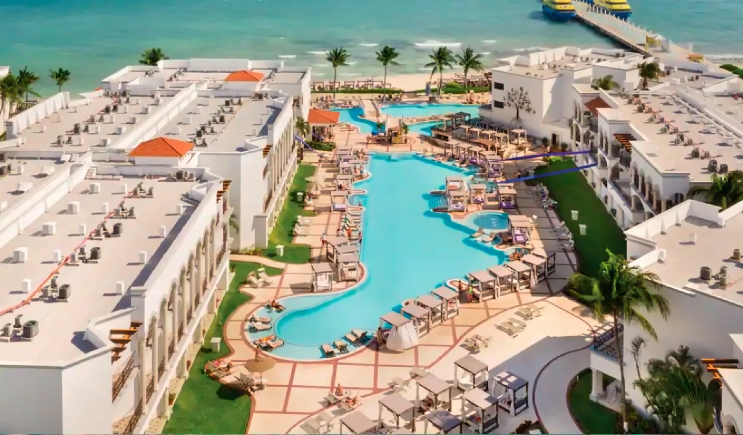 Aerial view of Hyatt Vivid Playa del Carmen featuring oceanfront pools, cabanas, and beachfront access.