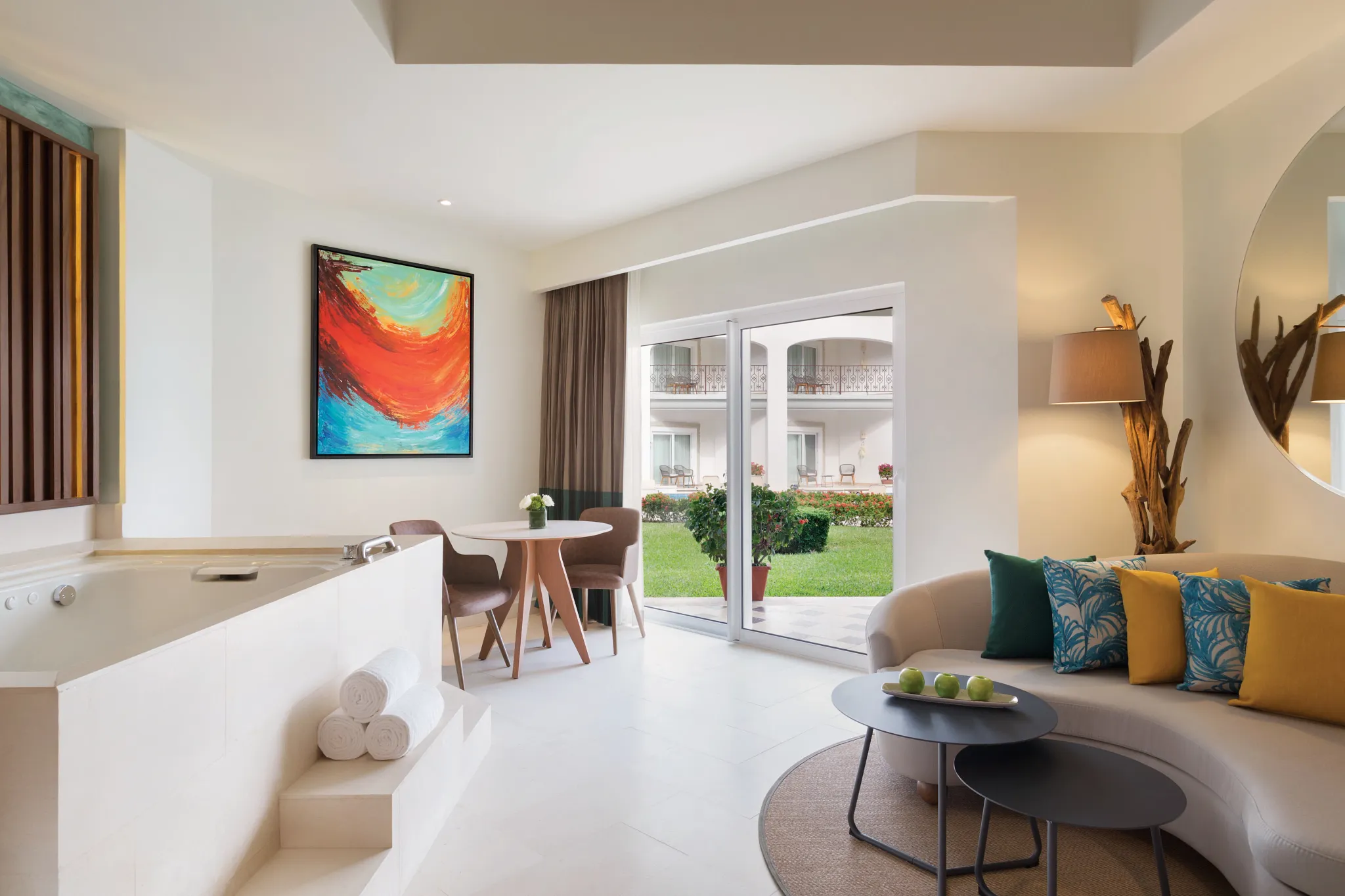 Junior Suite Garden View living area with jetted tub and furnished terrace at Hyatt Vivid Playa del Carmen.