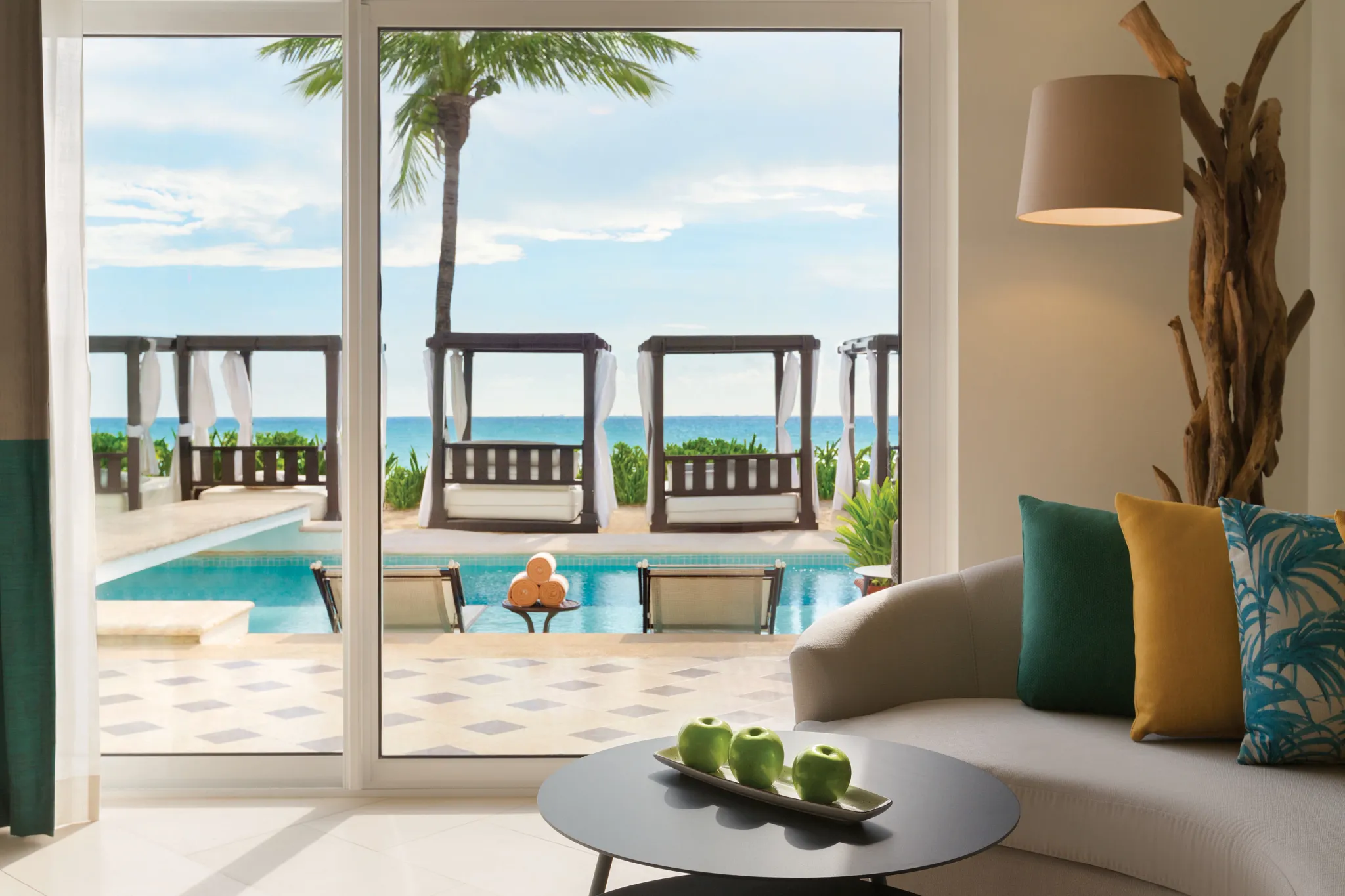 Junior Suite Swim-Up Oceanfront King overlooking pool cabanas and the Caribbean Sea at Hyatt Vivid Playa del Carmen.