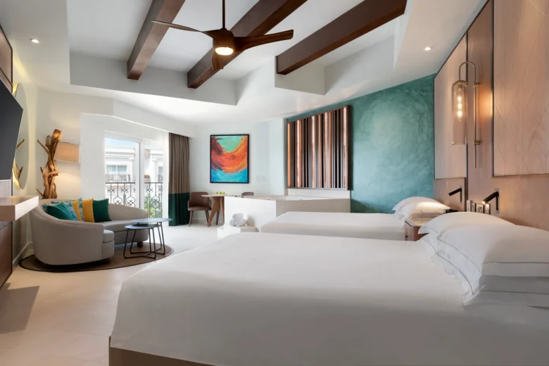 Junior Suite with two queen beds, double-jetted tub, and modern seating area at Hyatt Vivid Playa del Carmen.
